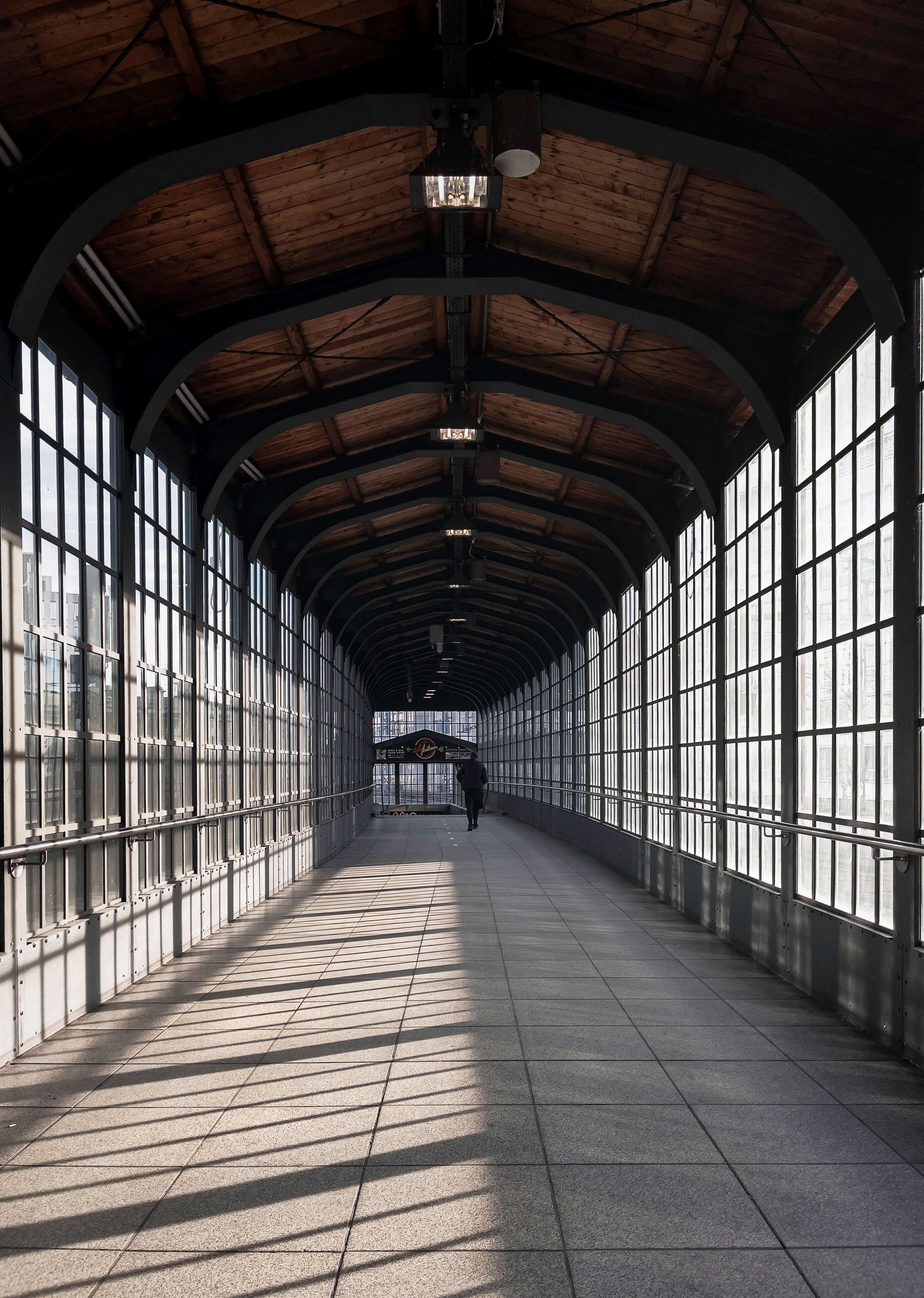 Photo of a tunnel with glass walls, while morning light shines through